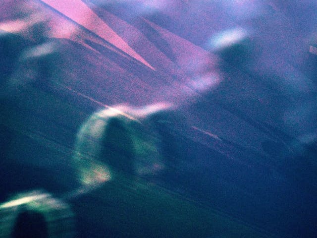 An abstract overlayed image of blurry people, shapes and colours.