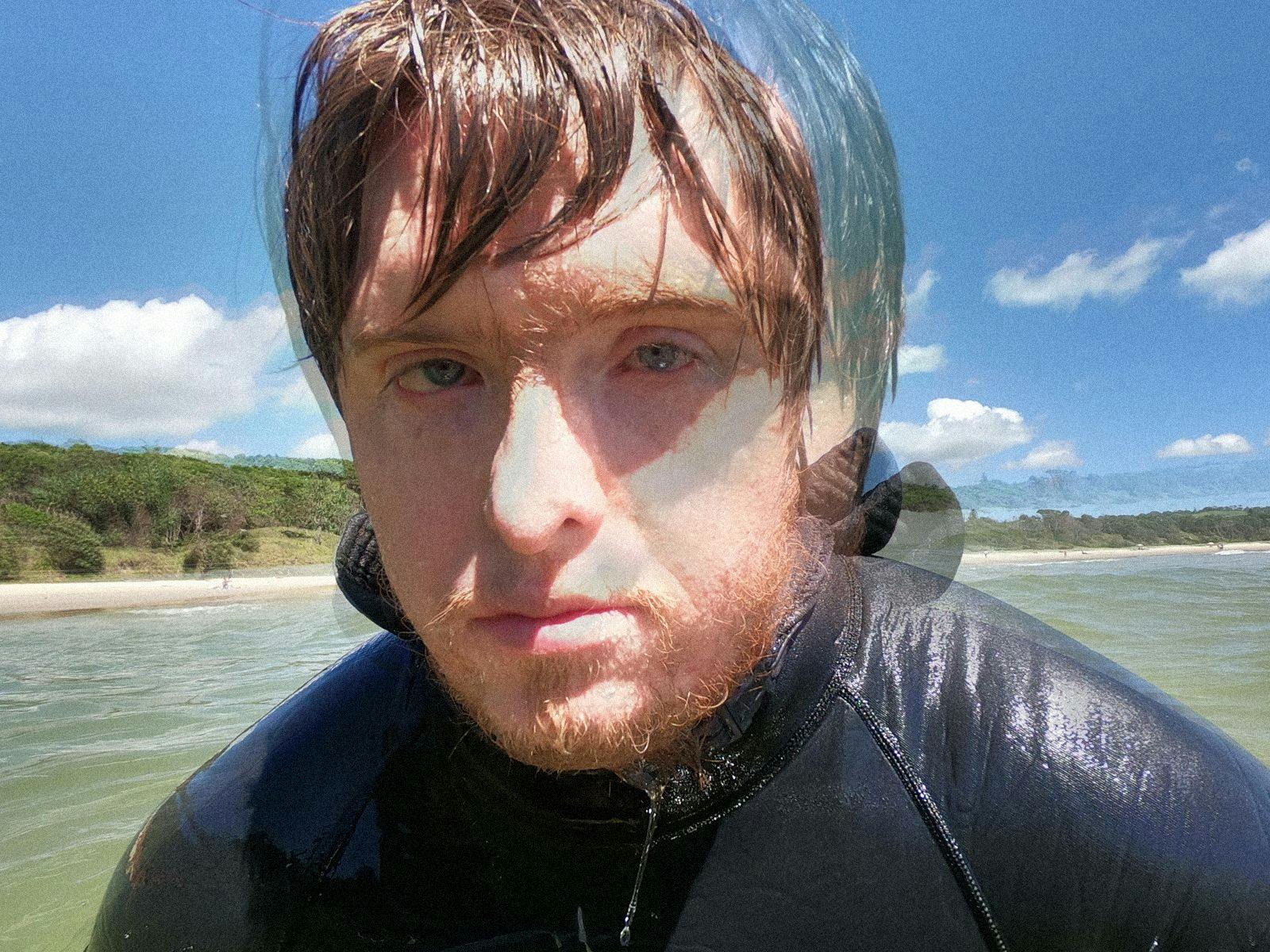 Lydian Dunbar swimming in the ocean, wearing a wetsuit.