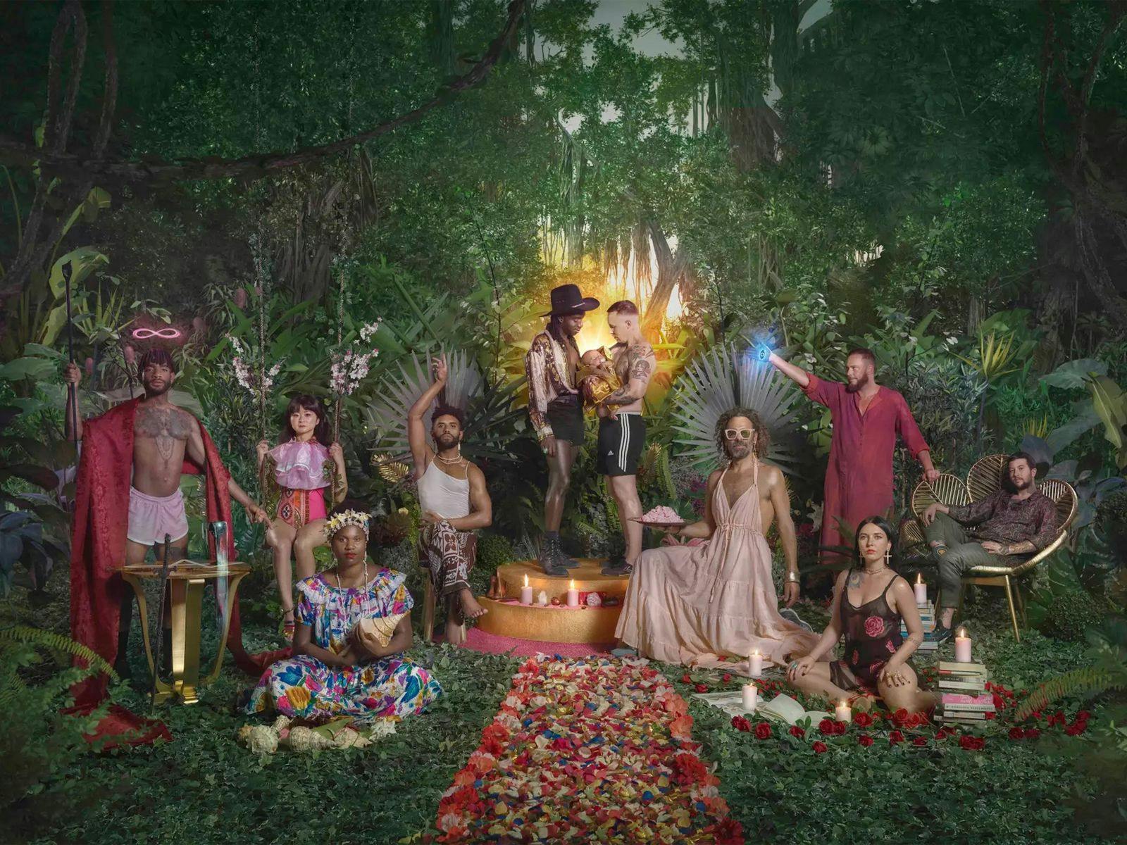 10 people stand in a jungle setting posing in various seated and standing positions.