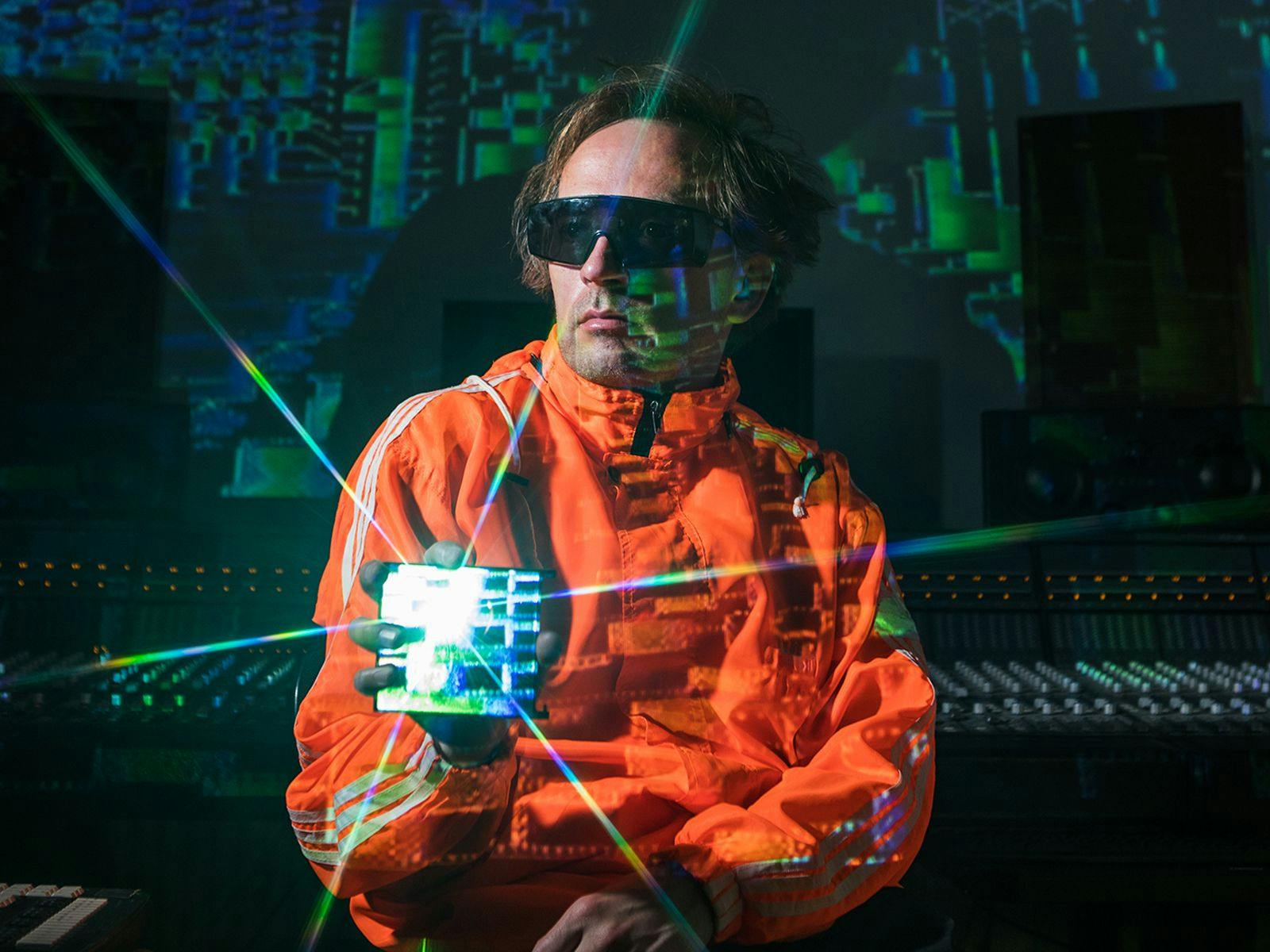 Image of Squarepusher holding a shiny cube.