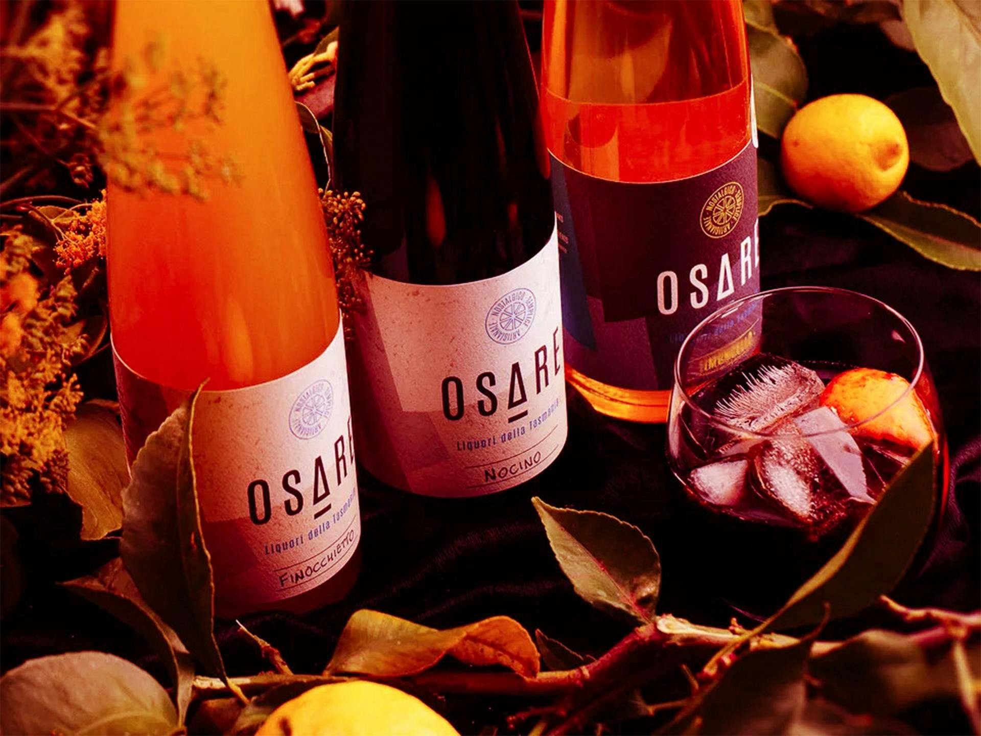 Three bottles of Osare and a cocktail amongst leaves