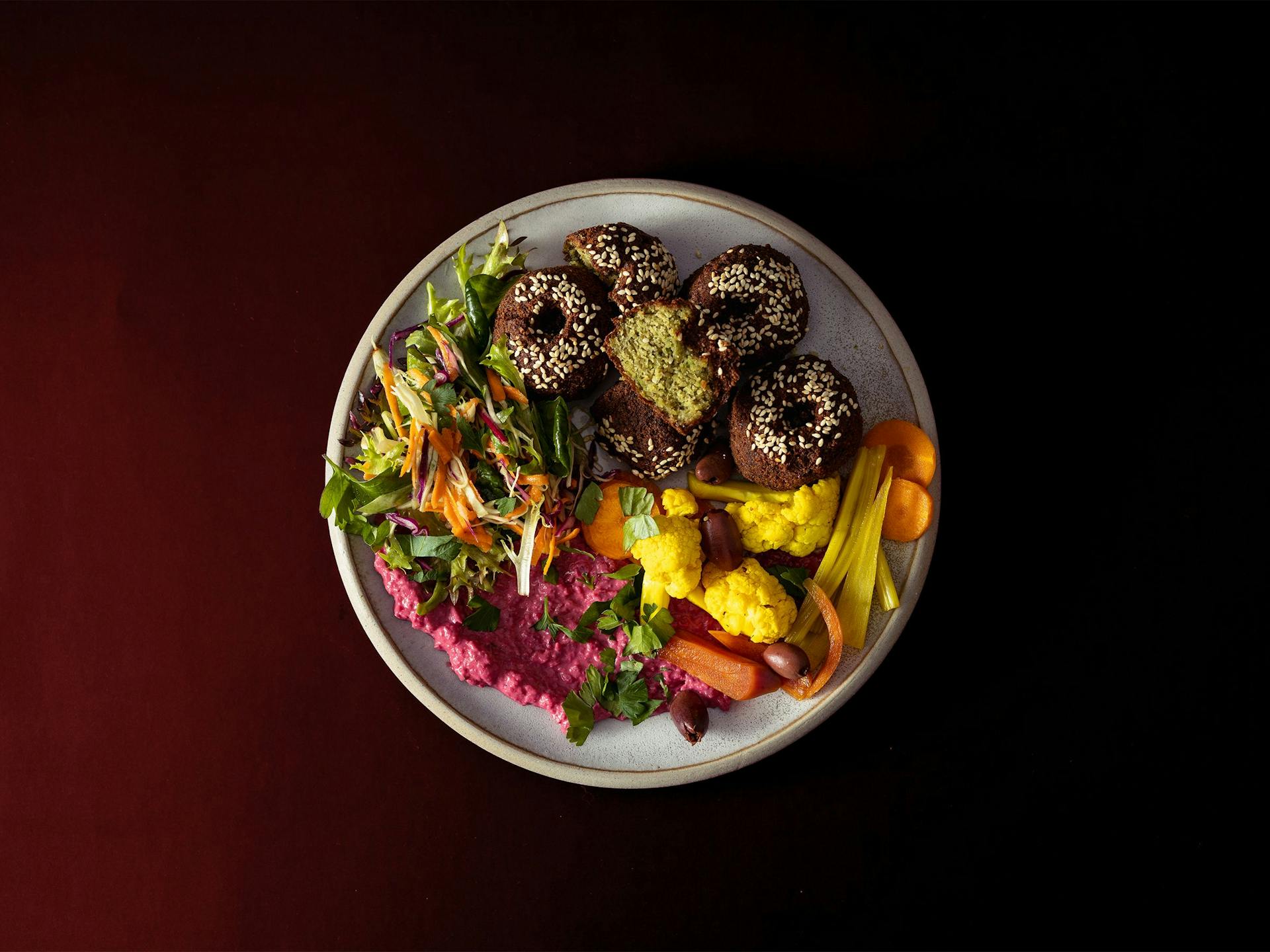 A big plate of falafel, hummus and pickled vegetables