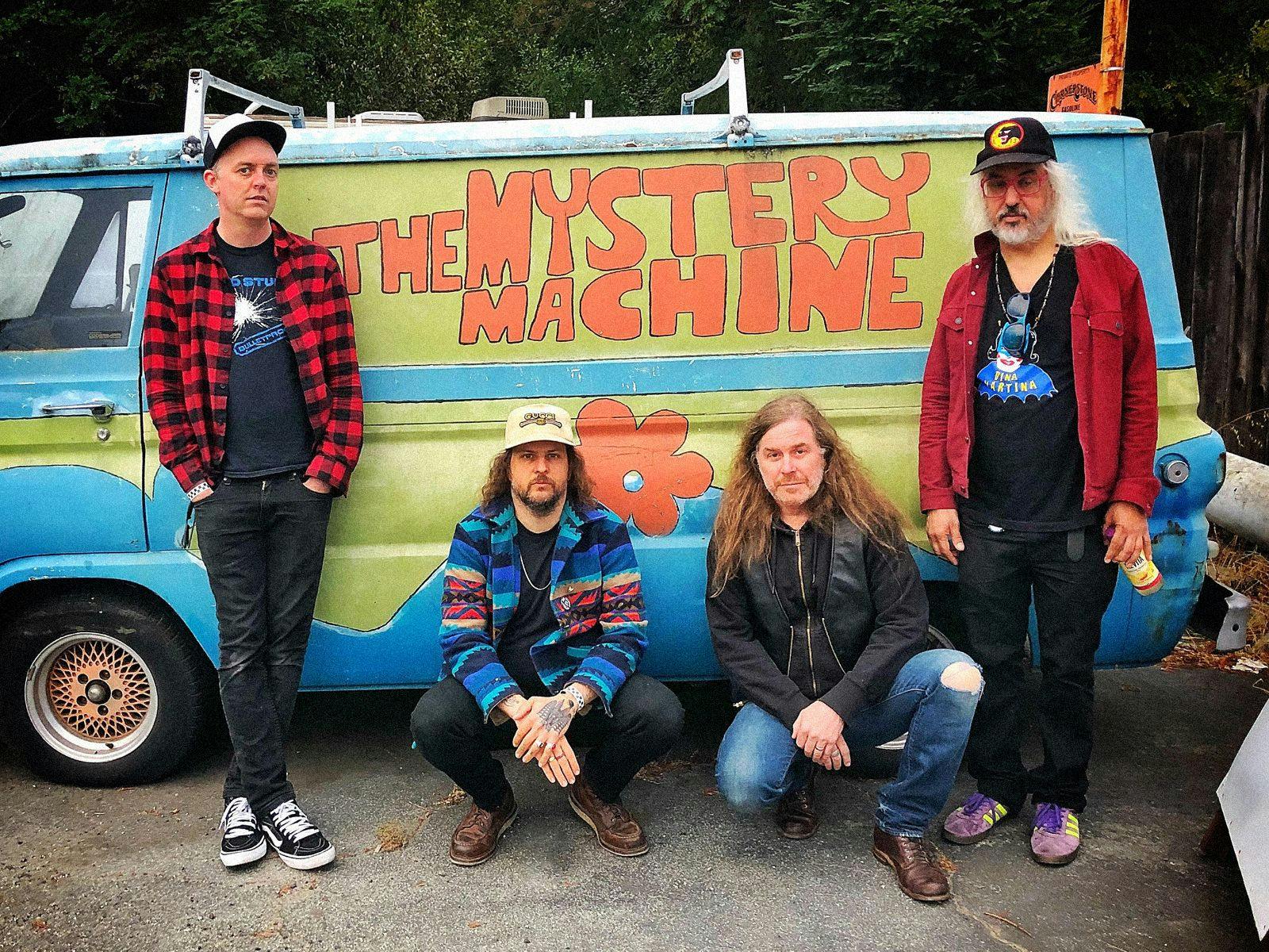 Members of Witch pose in-front of a replica 'The Mystery Machine' van.