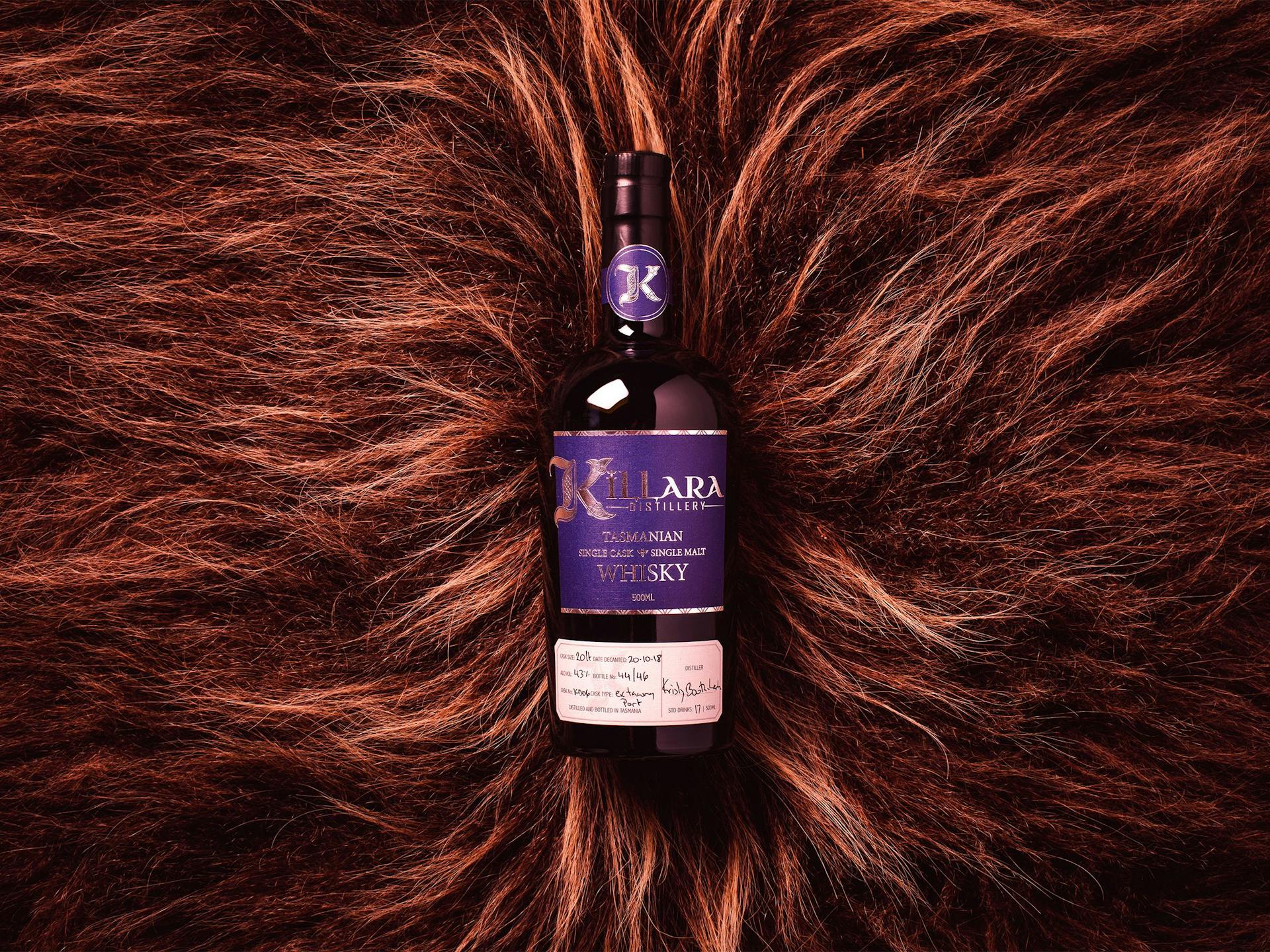 A bottle of Killara Whisky in a bed of animal hair