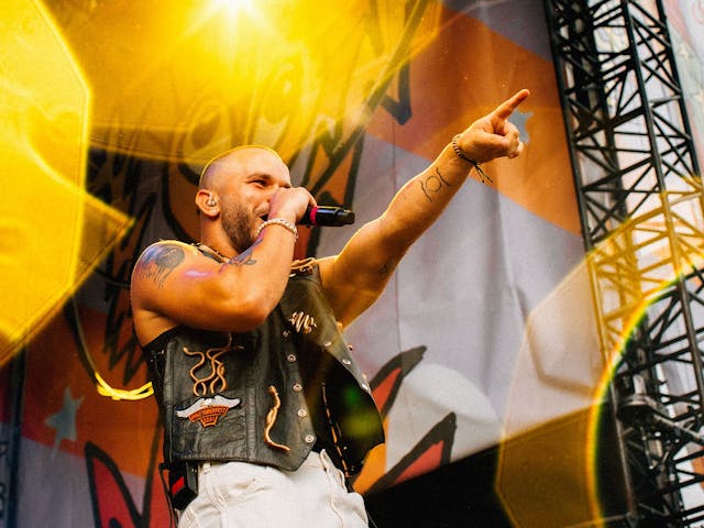 Tasman Keith performs on-stage, pointing out to the crowd.