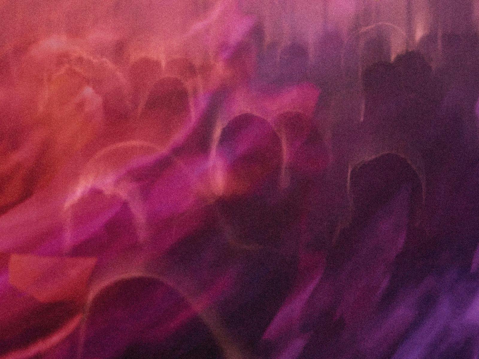 An abstract overlayed image of blurry people, shapes and colours.