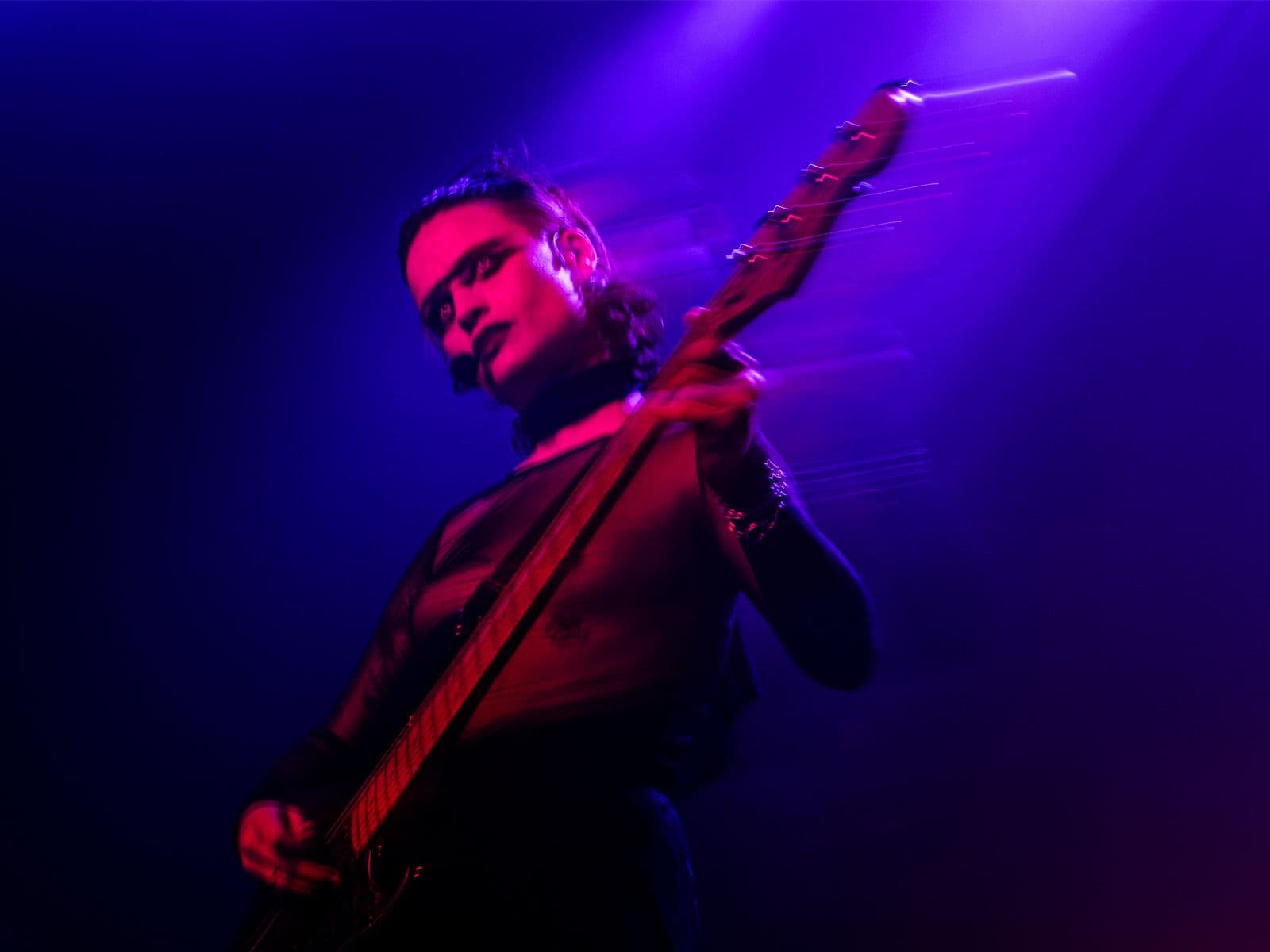 A blurred long exposure of V playing the guitar.