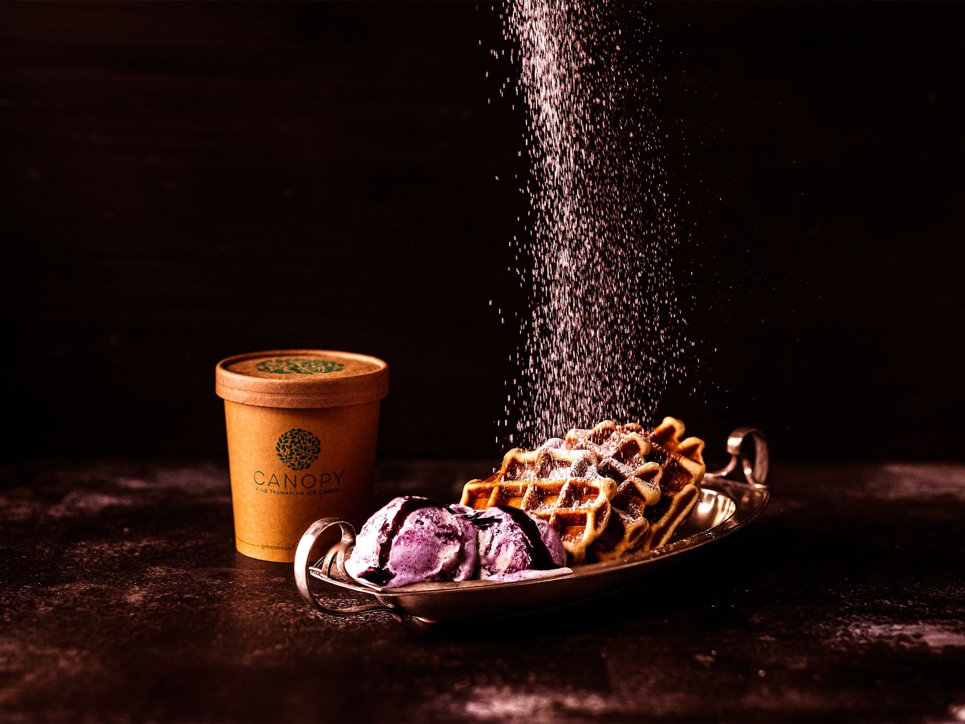 Waffles and ice cream dusted with icing sugar